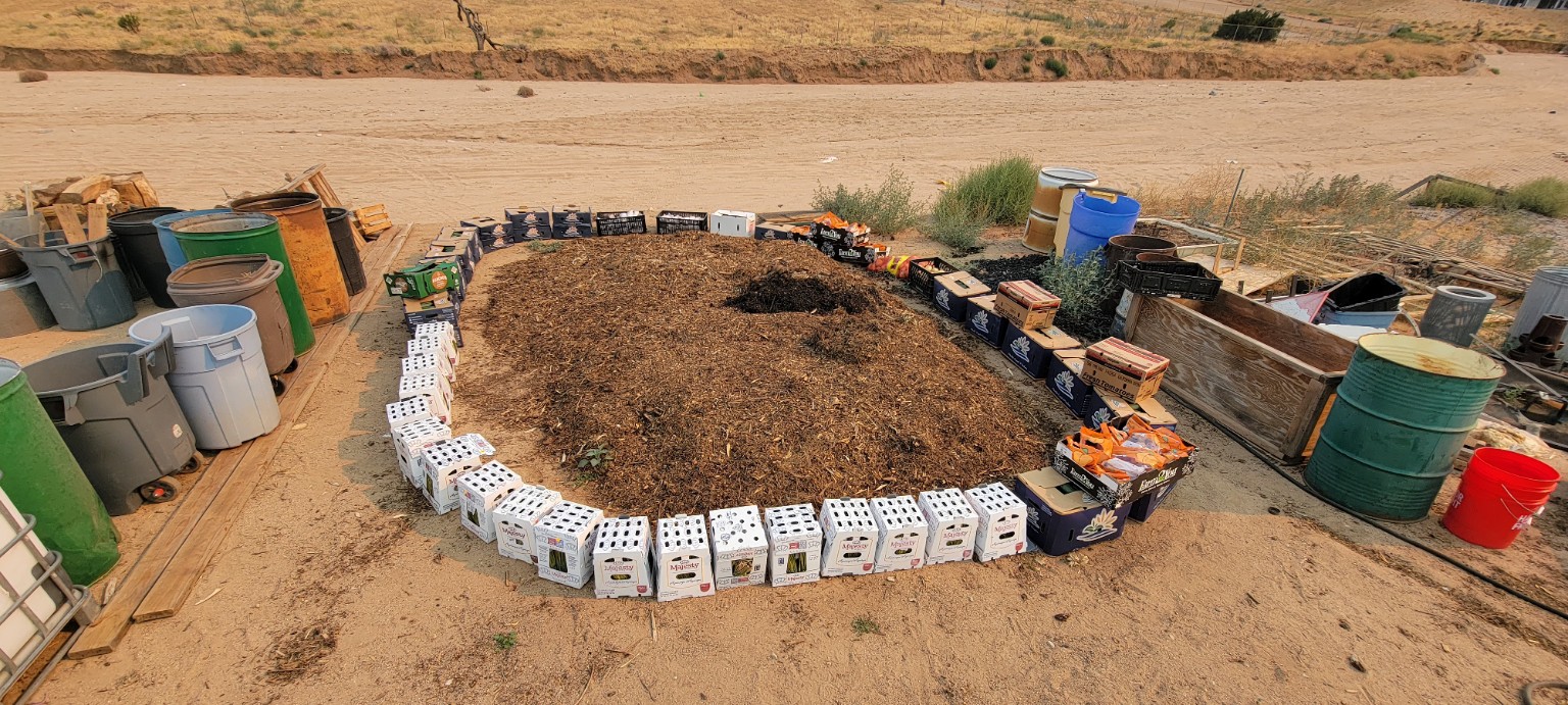 A large compost pile under construction in a High Desert yard